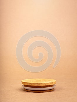 Round wooden stack as a podium with empty space for place food, cosmetics products designs isolated on recycle paper background.