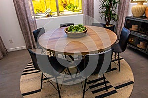 Round Wooden Table With Six Chairs In Eating Area