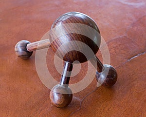 Round wooden table with three legs.