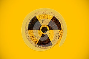 Round yellow and black radioactive hazard ionizing radiation nuclear danger warning symbol on rusty metal grungy texture