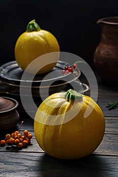 Round yellow courgette on rustic table