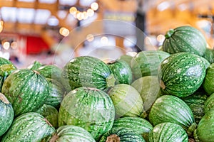 Round zucchini pile, being sold at a farmer`s market. Also referred to as round courgette. Unique, heirloom zucchini variety