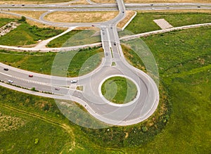 Roundabout and road intersection with traffic, aerial