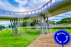 Roundabout sign by Modern bridge at Expresweg motorway Bruges Belgium