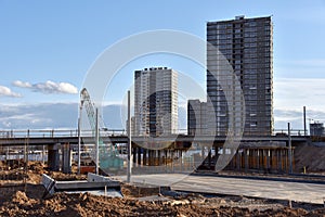 Roundabout and traffic bridge construction. Construction highway ramps and bridgeworks. Crane for formwork on bridge project works