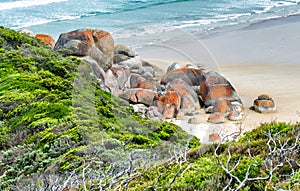 Rounded red rocks in Wilsons Promontory - Squeaky Beach
