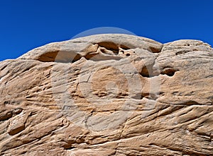 Rounded rock formations with honeycomb weathering along Notom Road in the Grand Staircase-Escalante National Monument, Utah, USA