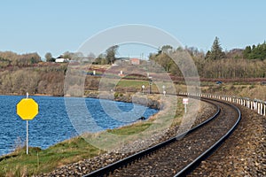 Rounding of railway along the lake. Empty turning single track of railways.