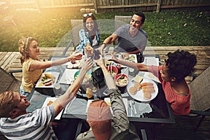 Rounding up the friends for an epic bbq. a group of friends having a barbecue in the yard.