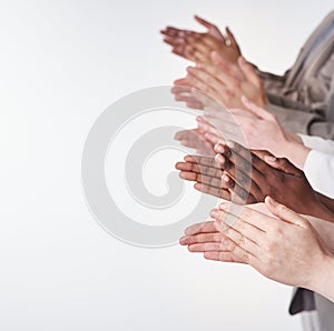 Rounds of applause. Shot of a group of people clapping their hands together.