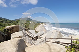 Roustic trekking path stairs with sierra nevada mountain range at background and caribbean sea