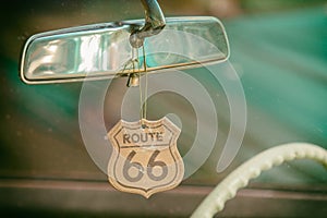 Route 66 badge hanging on a car mirror