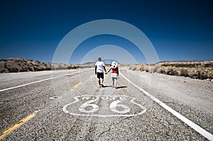 Route 66 - Couple of tourists walking on the famous highway