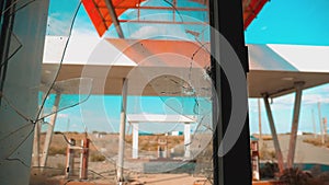 Route 66. crisis road 66 fueling broken window slow motion video. Old dirty deserted gas station. U.S. closed