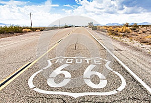 Route 66 road sign with blue sky background. Classic concept for travel and adventure in a vintage way