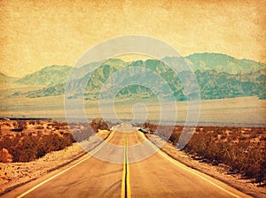 Route 66 crossing the Mojave Desert, California, United States.  Photo in retro style. Added paper texture. Toned image photo