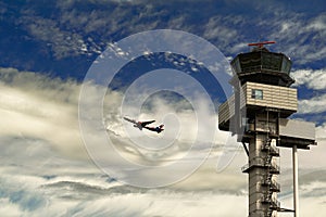 The route is the earth-sky. Passenger aircraft takes off against the background of the cloudy sky and the flight control tower at