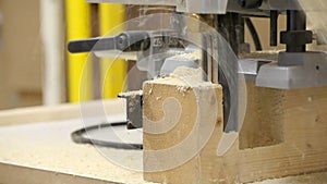 Router machine used on wooden plank in workshop