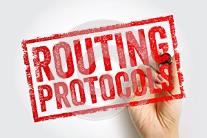 Routing protocols stamp held by hand, networking concept representing data transmission rules, internet communication systems,