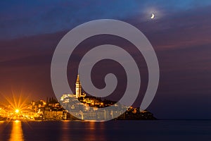 Rovinj old town at night with moon on the colorful sky, Adriatic sea coast of Croatia, Europe