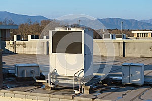 A row of air conditioning units on a rooftop.