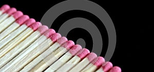 Row of aligned fire matchsticks on black background