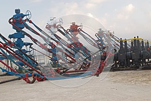 Row of American Oil Wells with zipper frac equipment