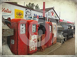 A Row of Antique Gasoline Pumps with Classic 1930`s Ford.