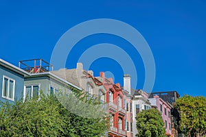 Row of apartments and townhome buildings with trees at the front- San Francisco, CA