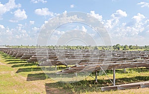 Row of back side view photovoltaics solar panels in solar power station