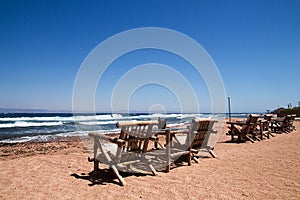 Row of bamboo chaise lounge on beach in Dahab, Sinai, Egypt. Be