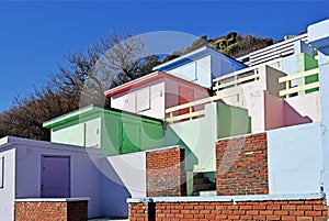 A row of beach huts with a blue sky background