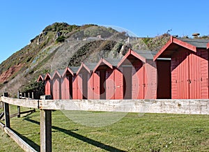 A row of beach huts on the shingle beach at Branscome in Devon, England