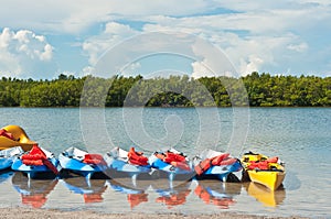 Row of beached kayaks waiting to be rented