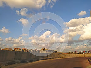 A row of beautiful houses under crowded white clouds