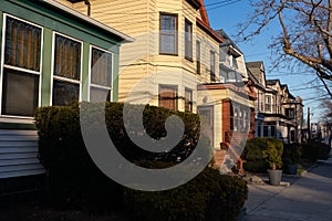 Row of Beautiful Old Wood Neighborhood Homes in Weehawken New Jersey along a Sidewalk