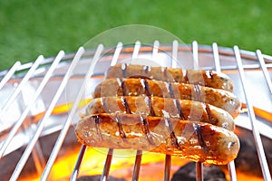 Sausages sizzling on a hot barbecue photo