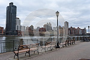 Row of Benches along the East River at Roosevelt Island and looking towards the Upper East Side Skyline of New York City