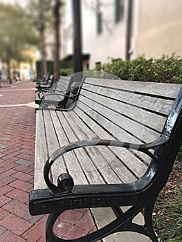 A row of benches in the old town city perfectly aligned. Photo image