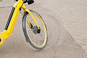 Row of bicycles parked. Yellow bicycles stand on a parking for rent. Pattern vintage bicycles bikes for rent on sidewalk in