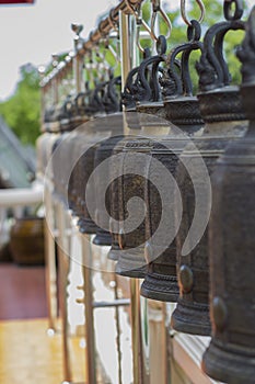 Row of big brass bell in temple, Thailand