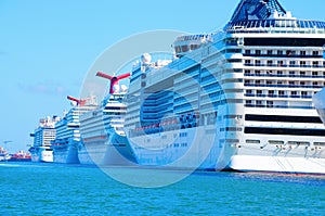 Row of big cruise ships in aqua colored water