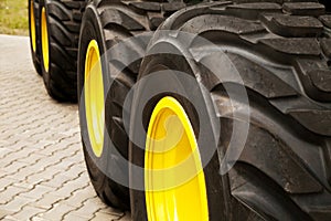 Row of big yellow truck wheels background