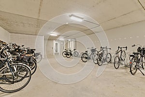 the row of bikes in the garage of a building