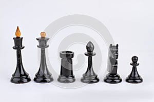 Row of black chess pieces isolated on white background.