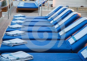 Row of Blue Chaise Lounges with Blue Spa Towels