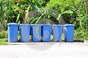 Row of blue dustbin by the roadside