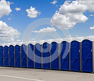 A row of blue portable toilets