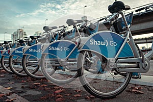 Row of blue Shaw Go Mobi bikes lined up near skytrain in Downtown Vancouver Canada