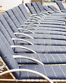 Row of Blue and Silver Chaise Lounges after Rain